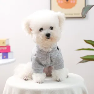Détail du cardigan gris pour animaux avec tissu tricoté doux et boutons sur un Bichon