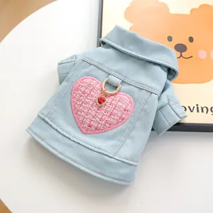 Detalle de chaqueta vaquera para perro con parche de corazón rosa y anillo metálico