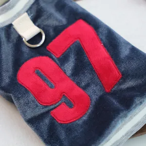 Detailed macro view of velvet pet vest with chenille number 97 and metal D-ring for leash