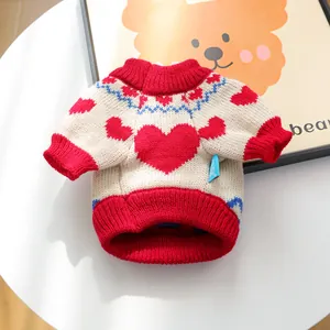 Close-up of heart pattern knit pet sweater with ribbed cuffs and woven brand tag