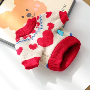 Close-up of pet knit sweater with red hearts, blue waves and ribbed edges for dogs