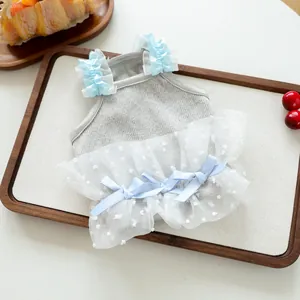 Lindo vestido para perros pequeños con top gris de canalé, falda de tul blanco y lazos azules.