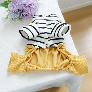 Detail of dog striped dress showing black and white cotton top with yellow corduroy skirt
