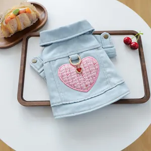 Detalle del chaleco vaquero para mascotas con parche de corazón rosa y anillo en D dorado