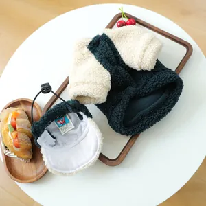 Cozy sherpa fleece pet vest and baseball hat set with adjustable drawstrings on wood tray