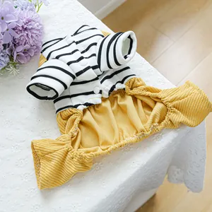 Detail of pet striped sweater and mustard corduroy overalls with white buttons