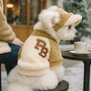 Detail of pet baseball cap and sherpa fleece coat with RB embroidery for small dogs