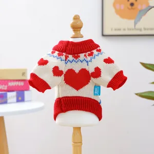 Detailed knit texture of heart pattern sweater for small pets on wooden hanger