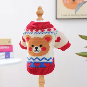 Detailed view of knitted pet sweater with cartoon bear and ribbed red trim details