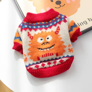 Close-up of orange monster pattern and knit texture on the pet sweater