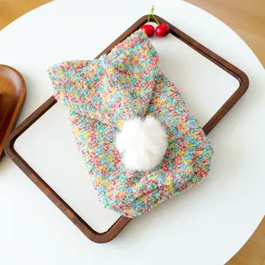 Colorful knitted pet hoodie for dogs and cats with a white pom-pom detail on the hood