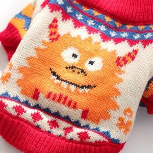 Close-up of knit pet sweater featuring orange monster pattern and red ribbed collar