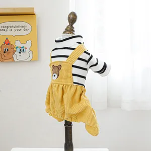 Detail of yellow corduroy pet overalls with bear patch and striped turtleneck shirt