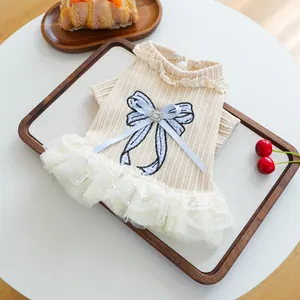 Detail of pet dress with blue plaid bow, lace collar and layered mesh tutu skirt