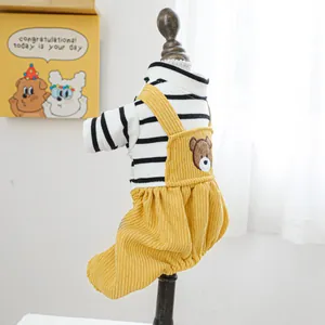Close-up of pet jumpsuit featuring yellow corduroy overalls with a cute bear patch