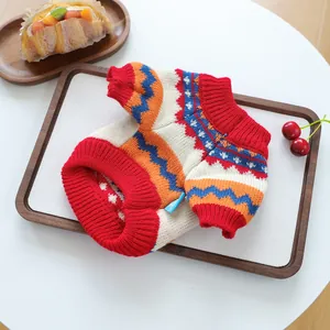 Detail of colorful geometric knit pattern and ribbed cuffs on small dog sweater