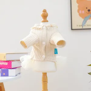 Detail of cream knit pet dress featuring lace collar and layered mesh tutu skirt