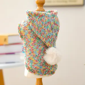 Detail of colorful confetti knit pet sweater featuring white pompom and soft texture
