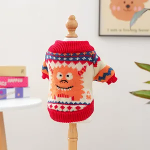 Detailed knit texture of orange monster sweater for small dogs on a wooden mannequin