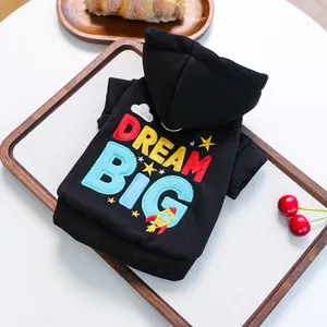 Close-up of black pet hoodie featuring colorful Dream Big embroidery and rocket details
