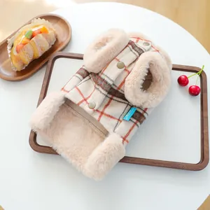 Detail of plaid pet vest showing plush faux fur lining and gold snap buttons