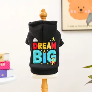 Detail of colorful DREAM BIG embroidery with stars and rockets on black pet hoodie