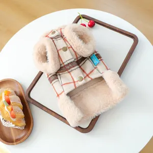 Detail of warm checkered pet vest with plush faux fur edges and golden buttons