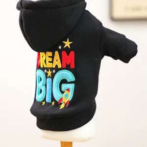 Macro shot of Dream Big embroidery on black pet hoodie with stars and rocket detail