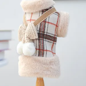 Detail of plaid pet vest featuring plush faux fur trim and knit bowknot decoration