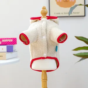 Detail of a white hooded pet fleece sweater with red trim on a wooden mannequin