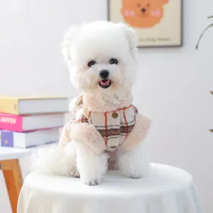 Plaid pet winter vest with faux fur trim and metal buttons on a white Bichon dog