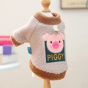 Detail of warm grey fleece pet vest with pink piggy embroidery and metal leash ring