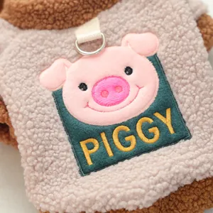 Detail of warm sherpa fleece pet vest with cute piggy embroidery and metal D-ring attachment