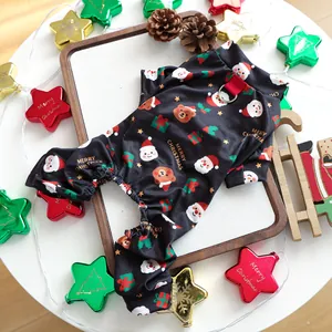 Détail d'un pyjama de Noël festif pour chien avec motifs de Père Noël et de cadeaux