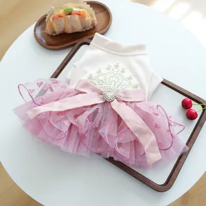 Detail of pet princess dress featuring pearl embroidery and a large satin bow on mesh skirt