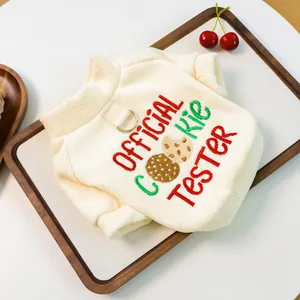 Close-up of cream knit pet sweater with Official Cookie Tester embroidery and D-ring