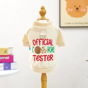 Detailed embroidery of Official Cookie Tester text on beige corduroy pet sweater