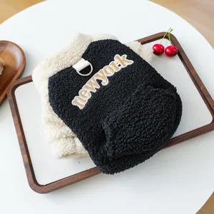 Detail of pet fleece vest featuring embroidered New York text and metal D-ring attachment