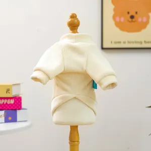 Detail of beige vertical knit pet sweater showing thick texture and blue side woven label