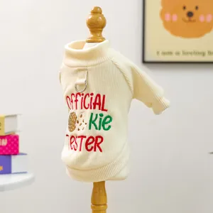 Detail of pet sweater showing official cookie tester embroidery and metal D-ring for leash