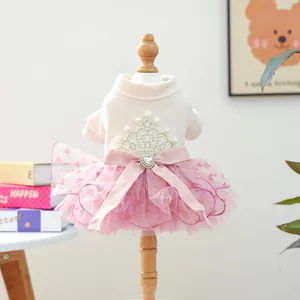 Detail of pet princess dress with crown embroidery, pink mesh skirt and rhinestone bow