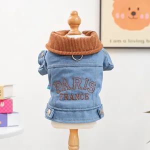 Detail of denim dog coat featuring Paris embroidery, corduroy collar and D-ring