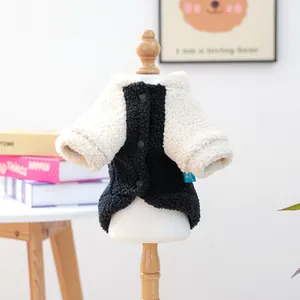 Close-up of cozy black and cream fleece pet vest with buttons and soft fuzzy texture