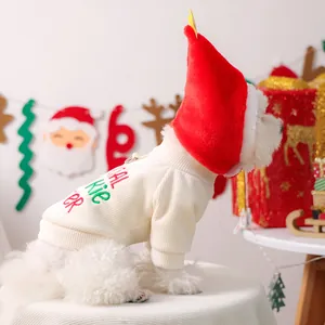 Detail of pet Christmas set featuring cream knit sweater and festive red velvet hat