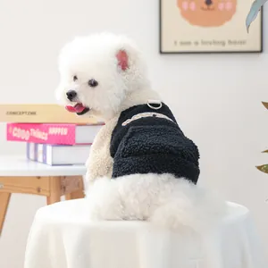 Detail of pet fleece vest with metal D-ring leash attachment and yellow embroidery