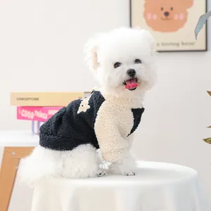 Detail of navy and cream sherpa fleece pet hoodie with yellow embroidery on a Bichon