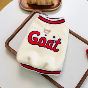 Detail of cream pet sweater with Goat embroidery, striped trim, and leash D-ring attachment