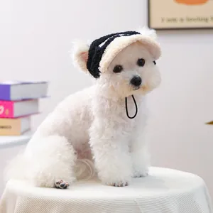 Detail of pet sherpa bucket hat in black and white with adjustable cord on white puppy