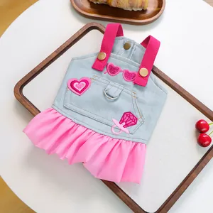 Detail of pink chiffon pet dress with denim top, heart embroidery and metal D-ring attachment