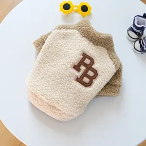 Detail shot of pet fleece vest featuring brown PB embroidery and soft plush fabric texture